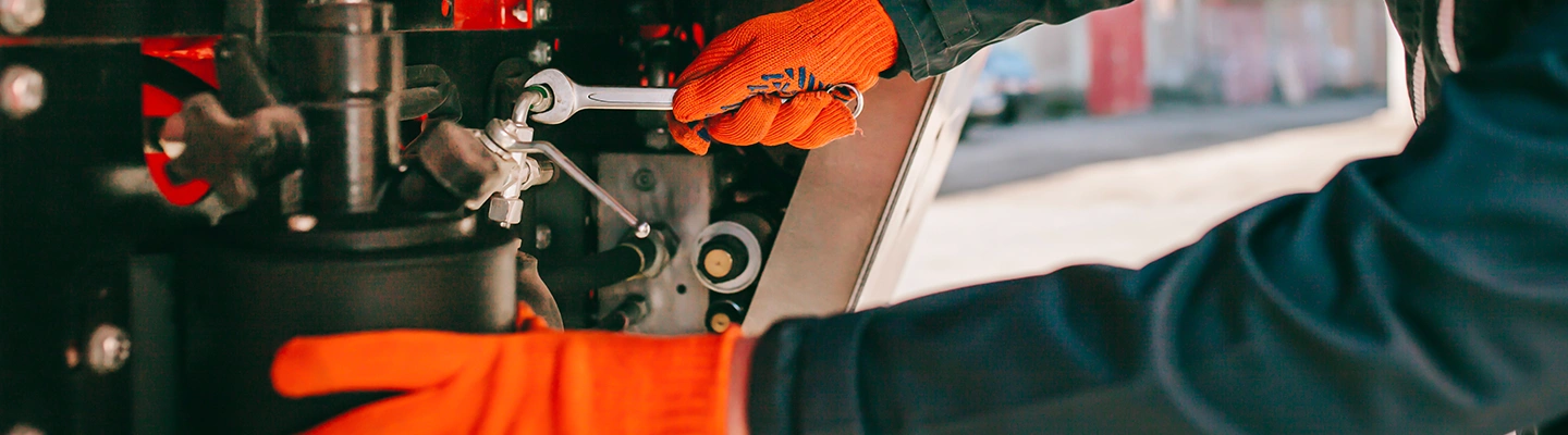 Service technician working on tractor