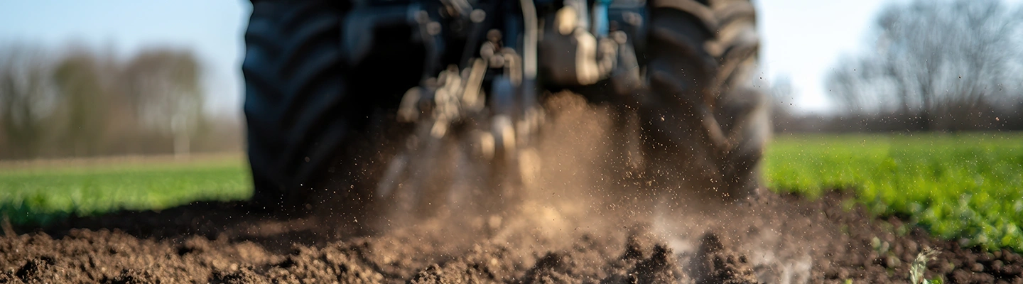 Tractor tilling field - close up